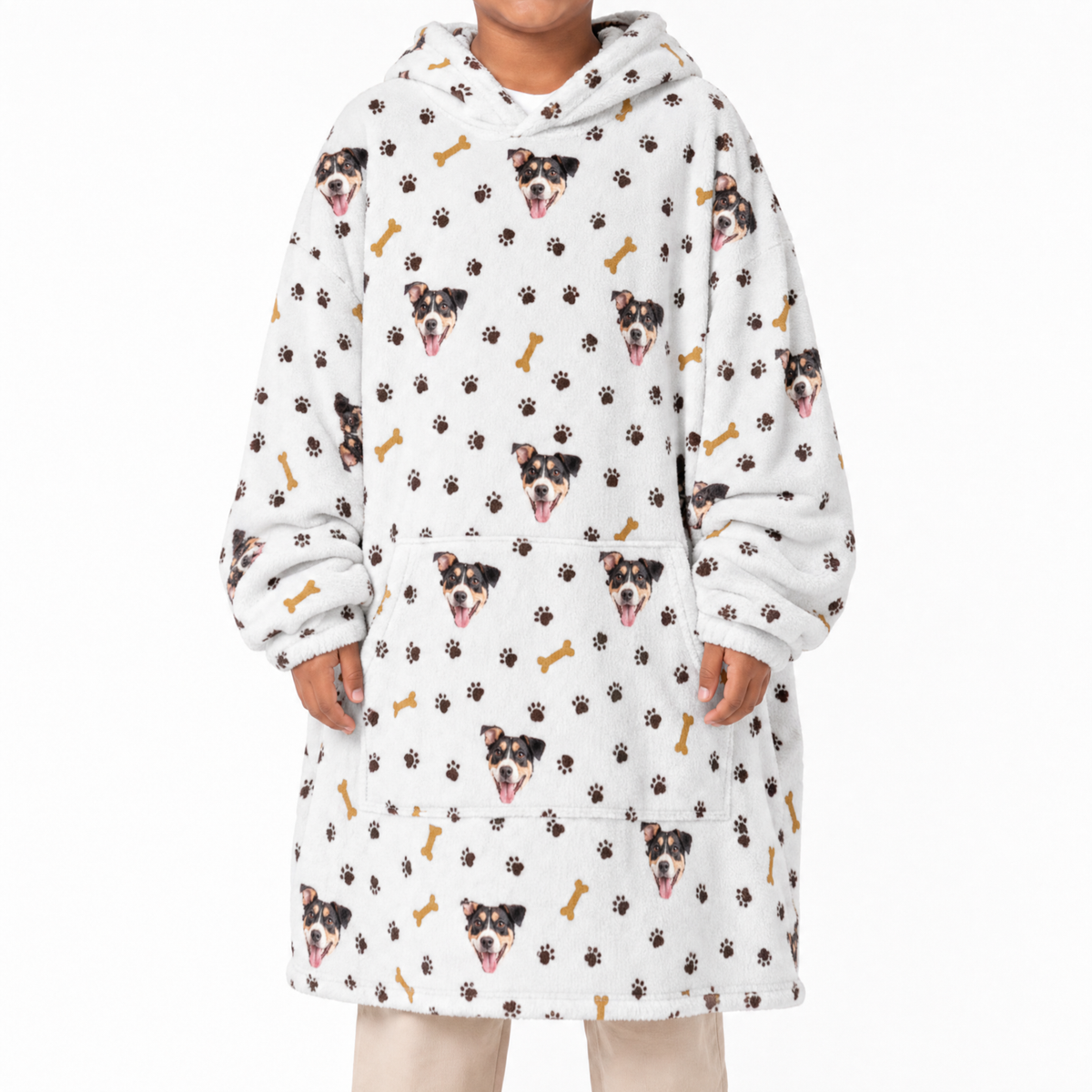 Person wearing a white blanket hoodie with dog and paw print pattern on a white background
