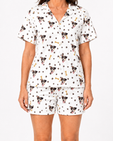 Person wearing a pajama set with dog print on a white background
