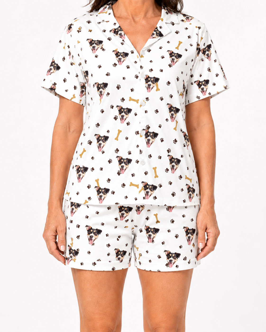 Person wearing a pajama set with dog print on a white background