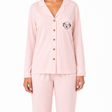 Pink pajama set with a dog illustration on the chest pocket against a white background