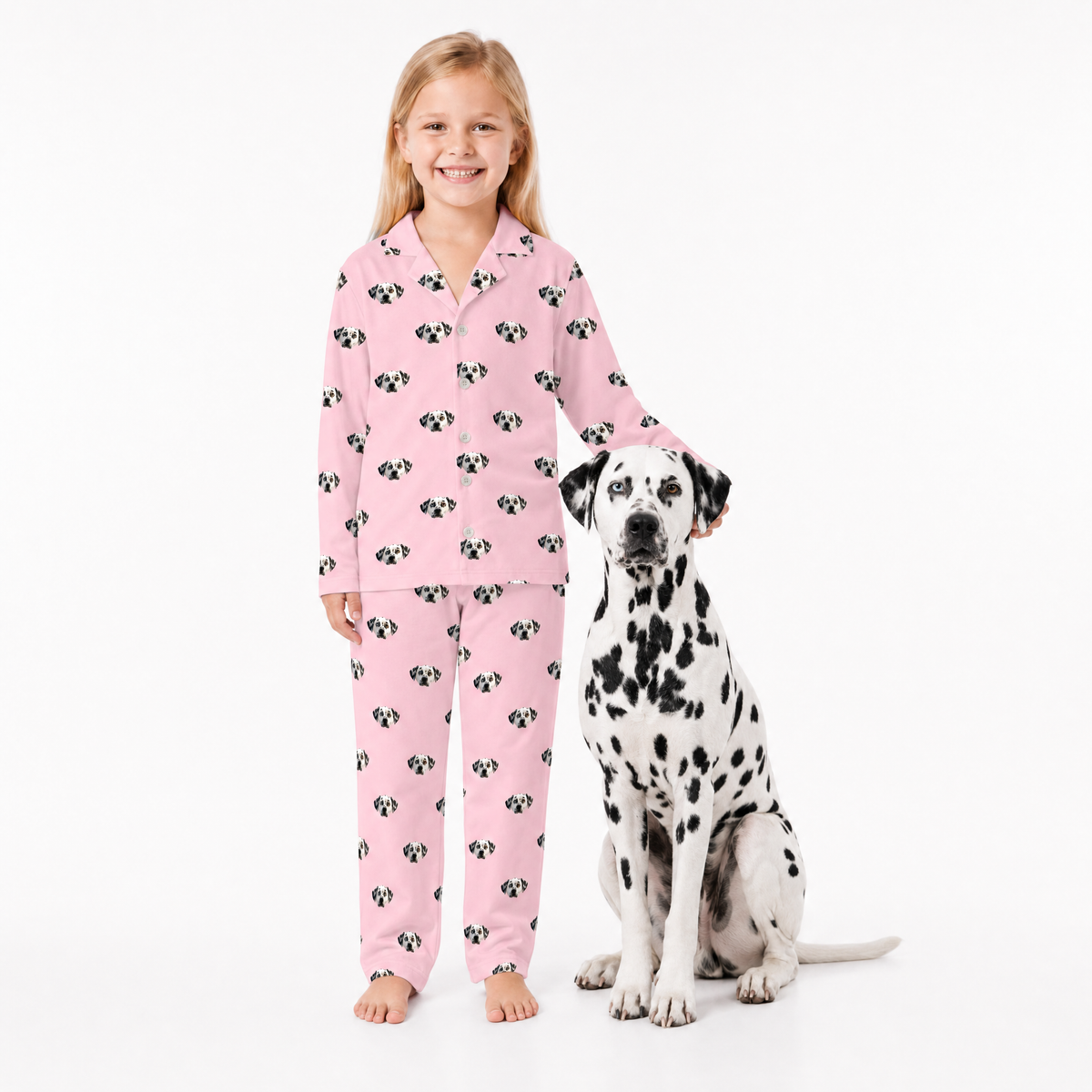 Girl in pink pajamas with dog on a white background