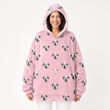 Person wearing a pink blanket hoodie with Dalmatian dog pattern on a white background