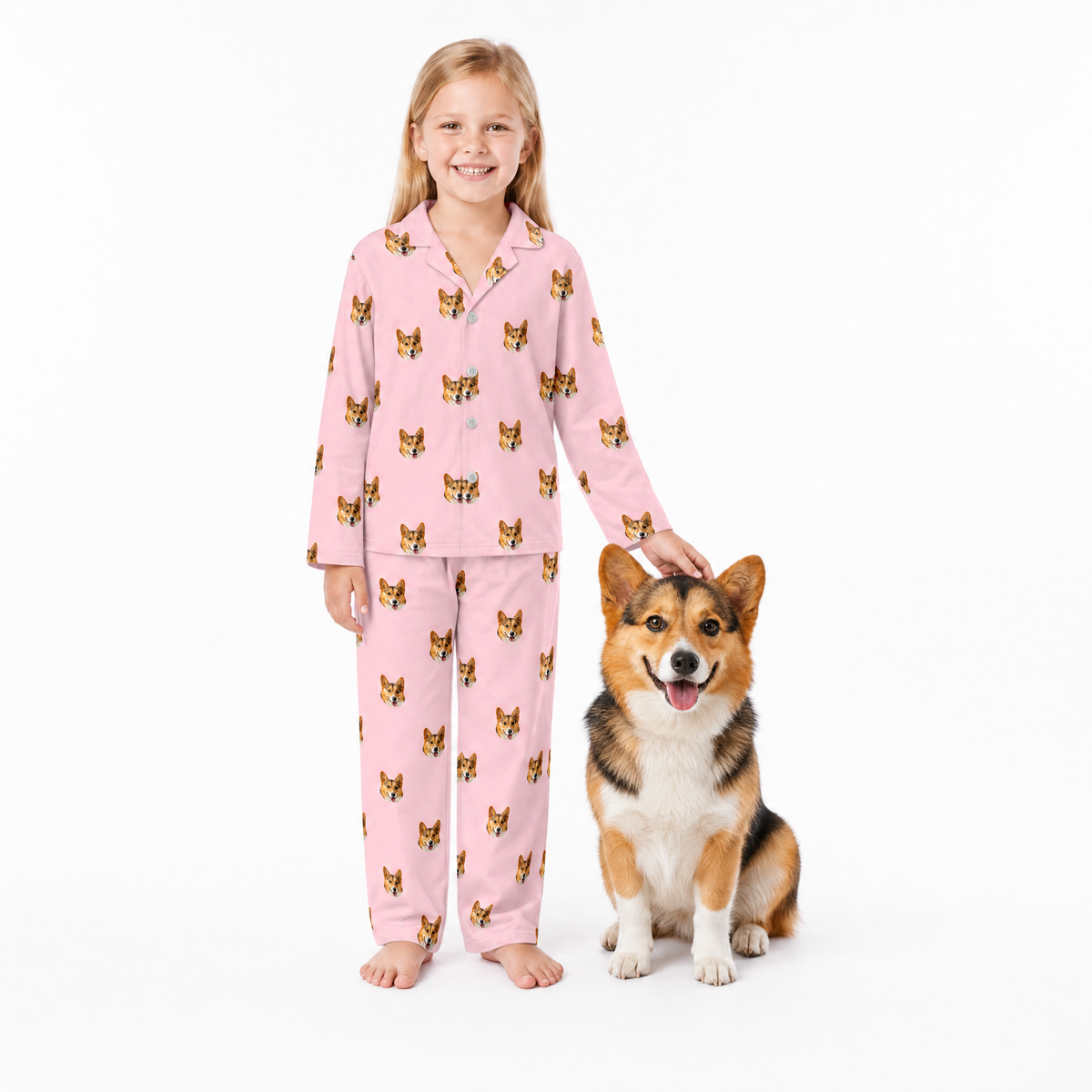 Girl in pink pajamas with a dog on a white background
