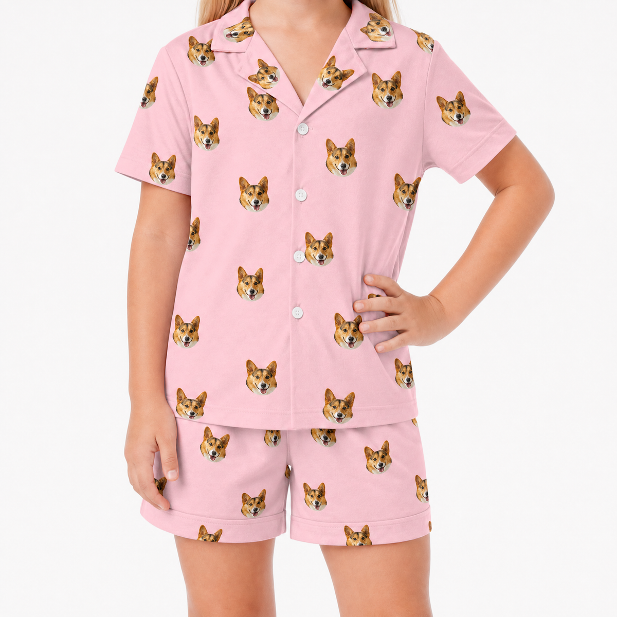 Pink pajama set with corgi pattern worn by a person on a white background