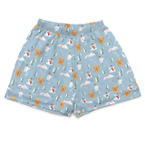 Light blue boxer briefs with an all-over Christmas dog print featuring golden retrievers, white dogs, snowmen, and pine trees.