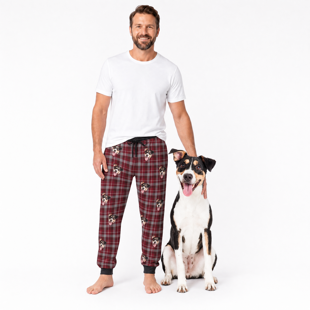 Man wearing plaid sweatpants with a dog on a white background