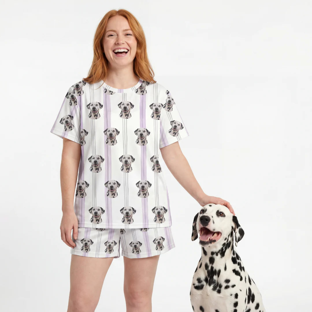 Woman wearing a Dalmatian patterned outfit standing next to a Dalmatian dog on a white background. [LilacStripes]