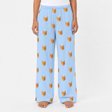 Sky blue pajama pants with cat pattern worn by a person on a white background