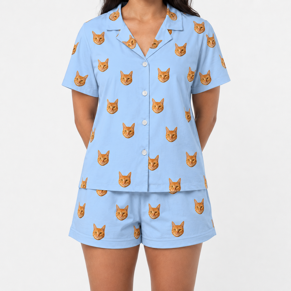 Sky blue pajama set with cat pattern on a plain background