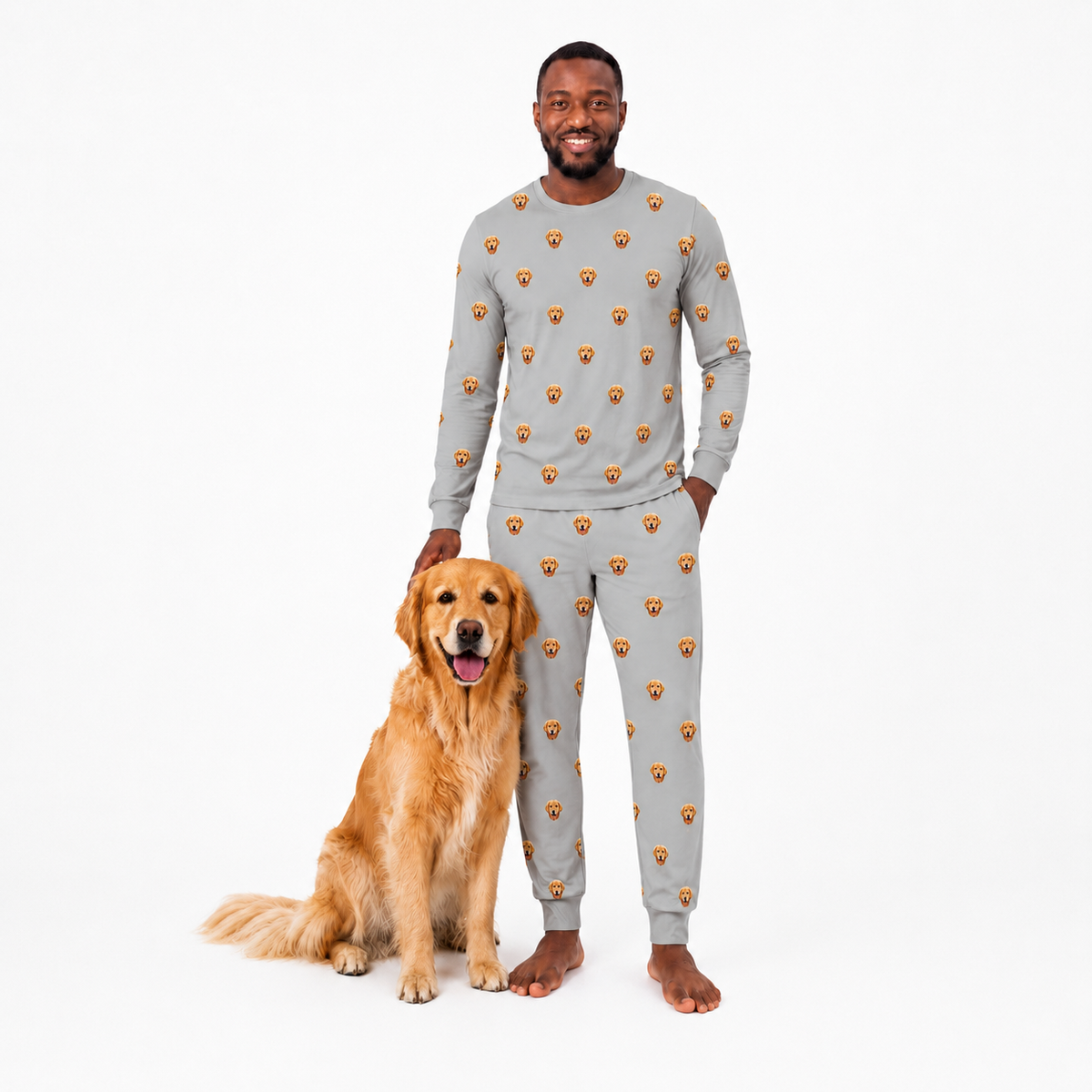 Man wearing a gray jogger pajama set with a dog sitting next to him on a white background
