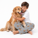 Child hugging a golden retriever dog on a white background