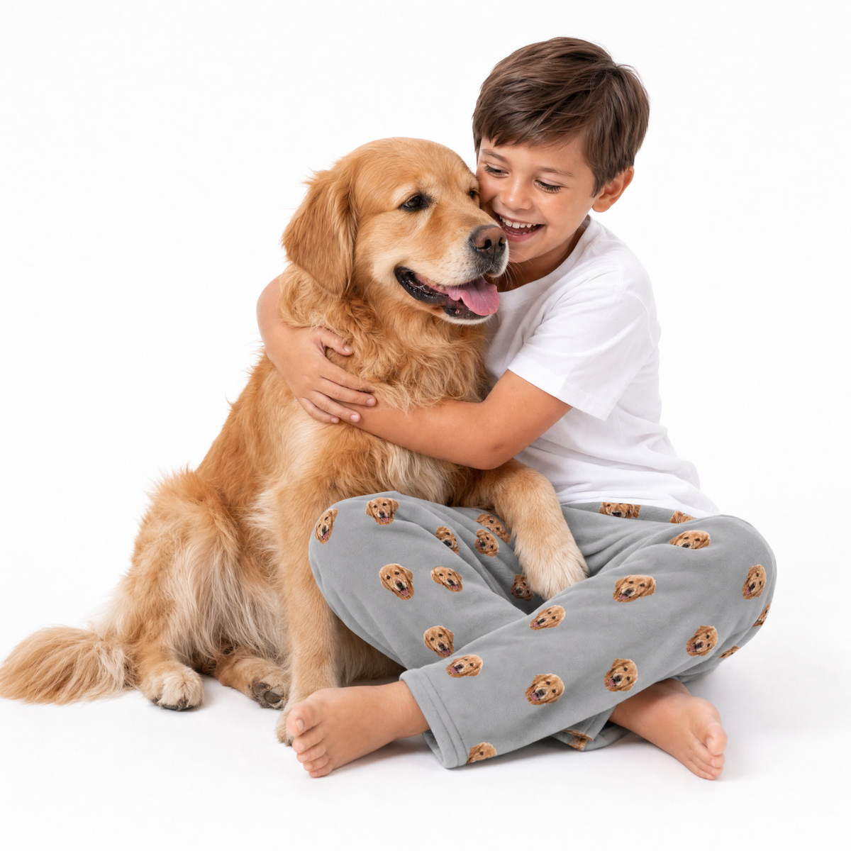 Golden retriever theme – child in slate gray dog-print pajamas hugging golden retriever.