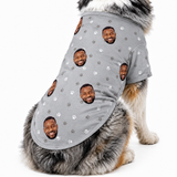 Dog wearing a gray custom dog shirt with paw prints and a repeating face pattern.