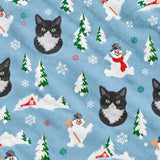 Close-up of the Snow Day print showing custom pet faces with snowmen, pine trees and snowy cottages on a light blue fabric