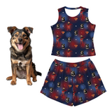 Dog with a matching superhero-themed tank top and shorts set on a white background