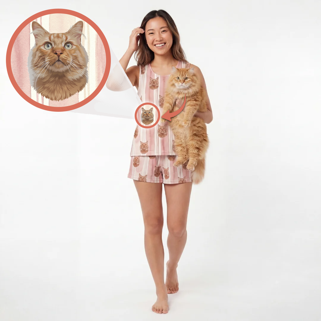 A woman stands barefoot against a white studio background, wearing a pink striped pajama set with a cat print and holding an orange tabby cat. A circular inset at the upper left shows a close-up of the cat print design with an arrow pointing to the matching pattern on the pajama top.