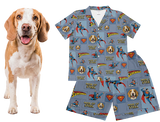 Dog next to a Superman-themed dog pajama set on a white background
