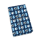 A rectangular gift box wrapped in navy blue holiday paper with a repeating pattern of Santa Claus circles and the words 'Merry Christmas,' tied with a thin brown string, shown on a plain white background.