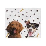 White blanket with paws and bones, featuring the illustrations of two dogs.
