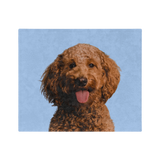 Blue blanket featuring a centered, smiling dog portrait.