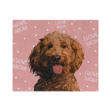 Pink blanket with hearts and the phrase "I Love Mom" featuring a centered, smiling dog illustration.