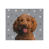 Gray paw print blanket featuring a centered, smiling dog illustration.