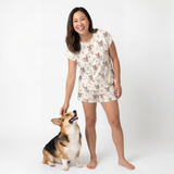 Woman wearing a fitted pajama set with a dog on a white background