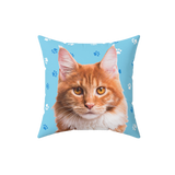 Blue pillow with paws, it features a portrait of a cat. [LightBluePawsImageCutOut]