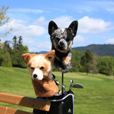 Two dog-shaped golf club covers on a golf bag with a golf course in the background
